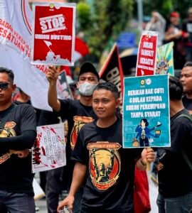ATRIBUT | Terlihat massa aksi memakai baju seragam dan membawa poster bernada protes. Hal tersebut menambah semarak dalam aksi hari buruh ini, Kamis (01/05/2025). | Jeremia Rafael Simamora