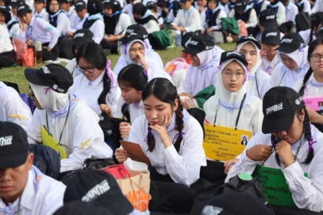 AMATI | Di tengah ramainya suasana PKKMB USU, seorang mahasiswa fokus menatap kertas yang ia genggam, Rabu (13/8/2025). | Imelda Sari Manalu