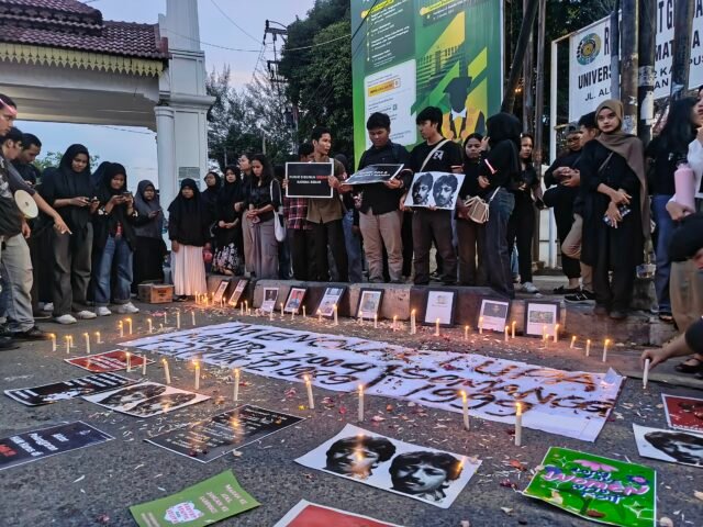 Massa menyalakan lilin dan menabur bunga pada aksi damai di depan pintu satu USU, untuk mendoakan para korban pelanggaran HAM di Indonesia, Jumat (12/9/2025). | Muhammad Rifqy Ramadhan Lubis